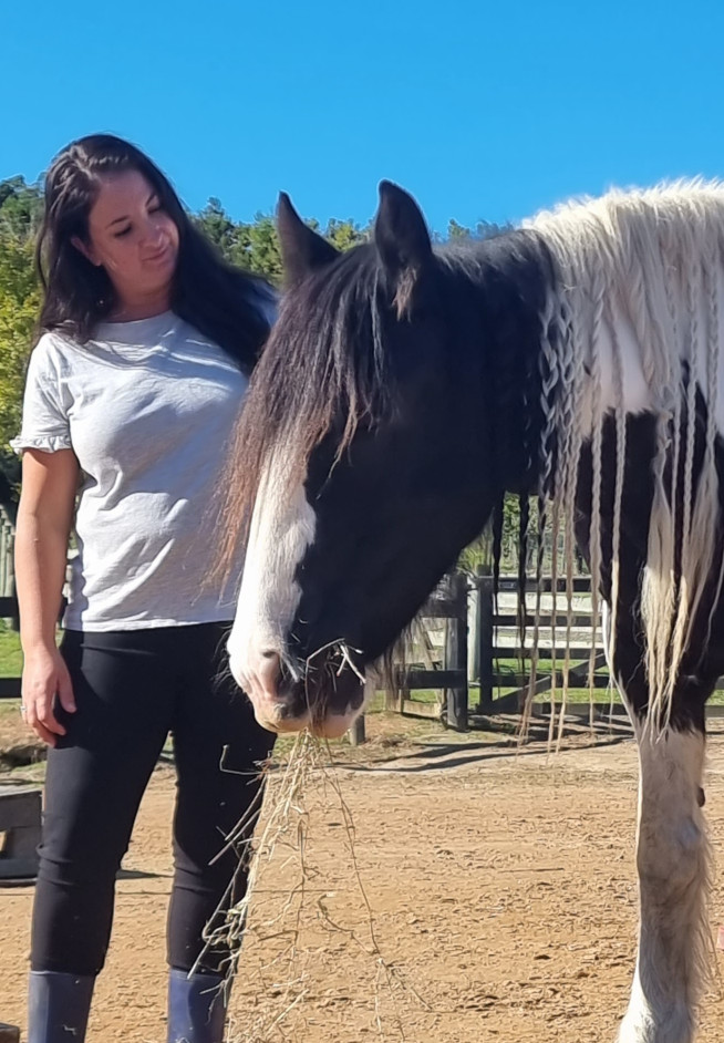 Therapist standing close to horse